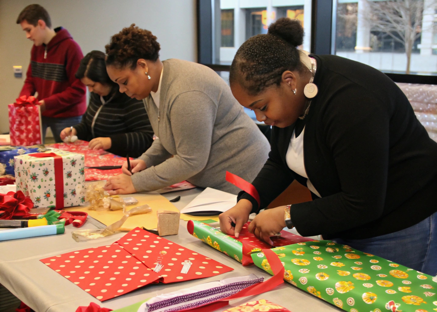 Participants in a gift wrapping workshop practicing techniques with various wrapping papers and ribbons
